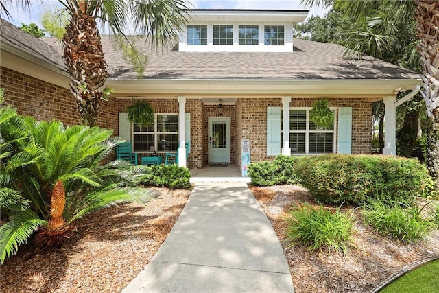 100 Southern Oaks Ln, Saint Simons Island, GA 31522 - property entrance featuring covered porch, brick siding, and a shingled roof