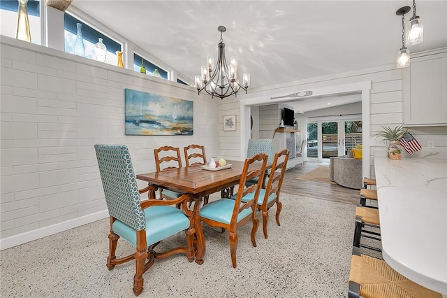 dining area featuring baseboards and a notable chandelier