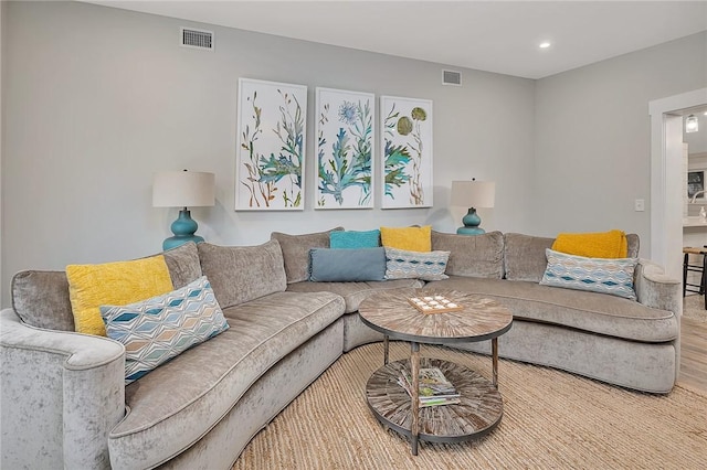 living area featuring wood finished floors, visible vents, and recessed lighting