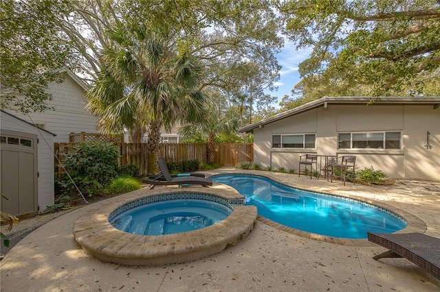 view of swimming pool featuring a fenced in pool, an outbuilding, a patio area, an in ground hot tub, and a fenced backyard