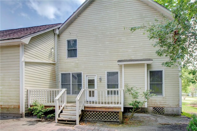 back of property featuring a patio and a deck