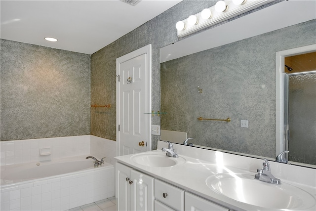 bathroom with tile patterned flooring, vanity, and shower with separate bathtub