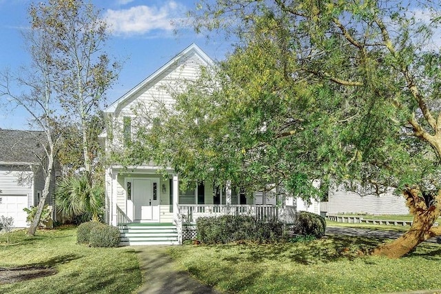 view of property hidden behind natural elements featuring a porch and a front yard