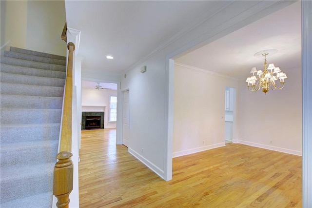 112 Newfield St, Saint Simons Island, GA 31522 - spare room with light wood-style floors, stairway, ornamental molding, ceiling fan, and a chandelier