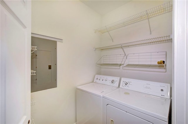 laundry area with independent washer and dryer and electric panel