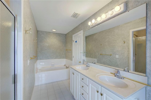 bathroom with tile patterned floors, vanity, and plus walk in shower