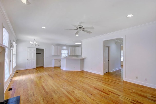 unfurnished living room featuring crown molding, light hardwood / wood-style flooring, and ceiling fan with notable chandelier