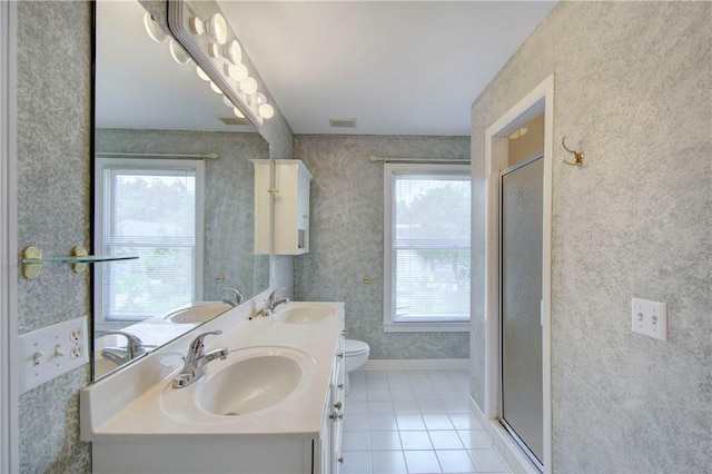 bathroom featuring tile patterned floors, vanity, an enclosed shower, and toilet