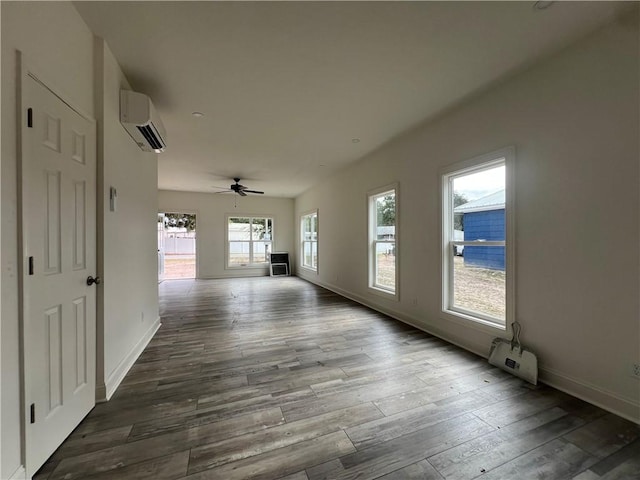 1011 Elbert St, Darien, GA 31305 - interior space featuring a wall mounted air conditioner, ceiling fan, and hardwood / wood-style floors