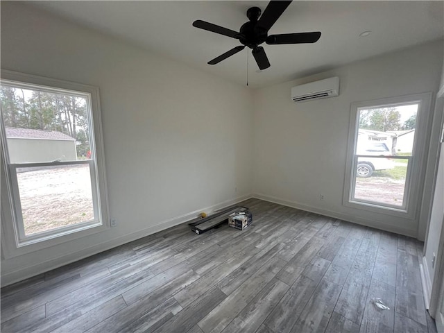 empty room featuring light wood-type flooring, a wall mounted AC, and ceiling fan