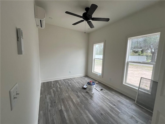 1011 Elbert St, Darien, GA 31305 - spare room featuring hardwood / wood-style flooring, an AC wall unit, and a healthy amount of sunlight