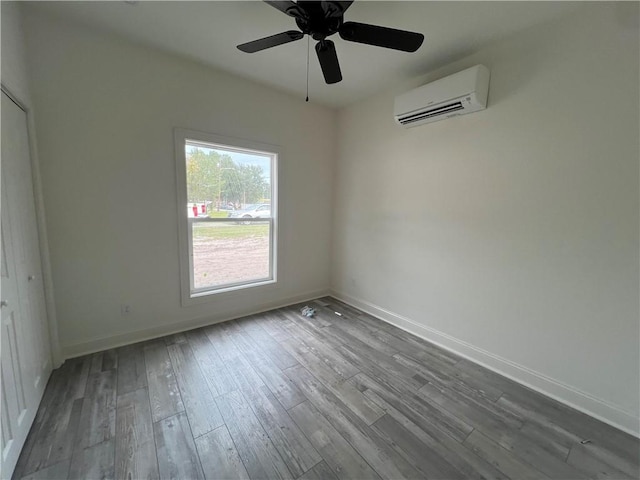 1011 Elbert St, Darien, GA 31305 - empty room featuring ceiling fan, wood-type flooring, and a wall unit AC