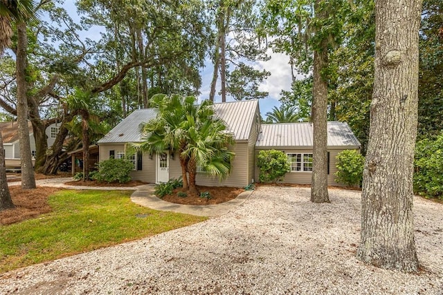 205 Palmetto St, Saint Simons Island, GA 31522 - single story home featuring gravel driveway and a metal roof