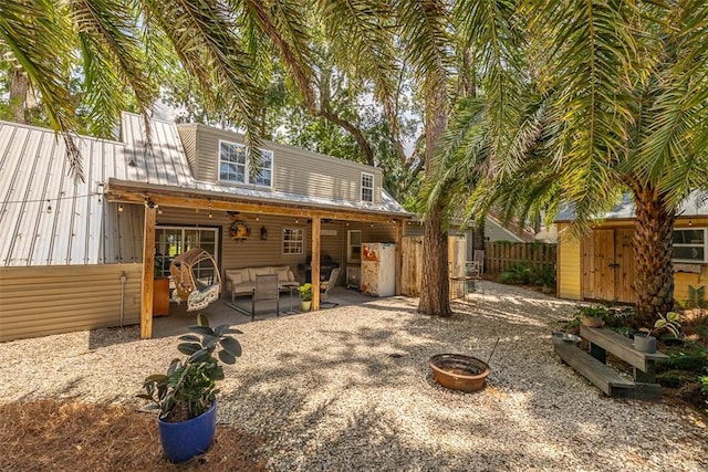 205 Palmetto St, Saint Simons Island, GA 31522 - back of house featuring a patio area, an outdoor living space with a fire pit, and a shed