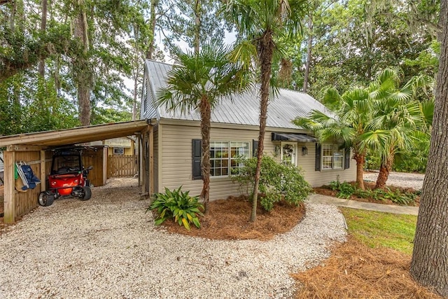 205 Palmetto St, Saint Simons Island, GA 31522 - view of front of property with a metal roof, a carport, and gravel driveway