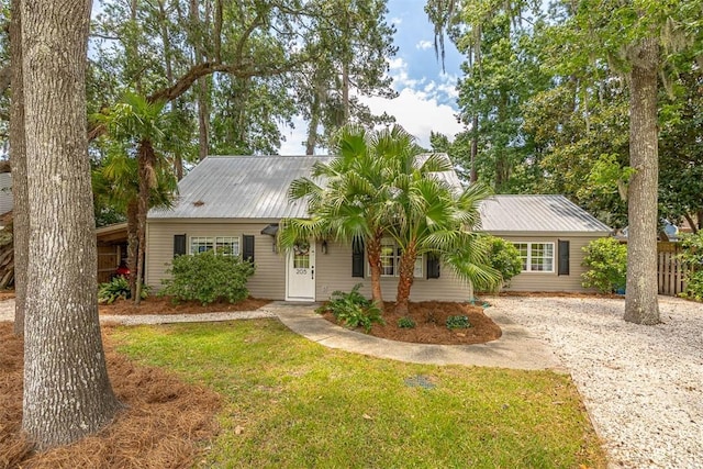 205 Palmetto St, Saint Simons Island, GA 31522 - ranch-style home with a front yard, a metal roof, and driveway