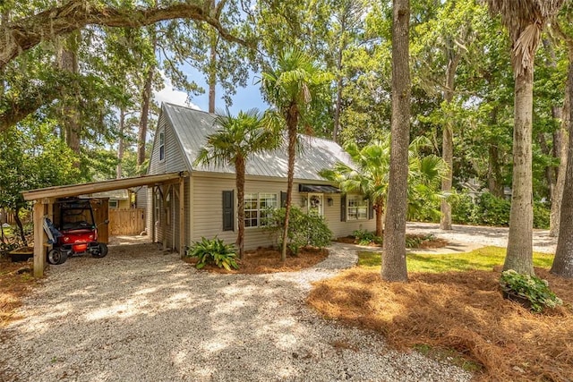 205 Palmetto St, Saint Simons Island, GA 31522 - view of front facade featuring driveway and a metal roof