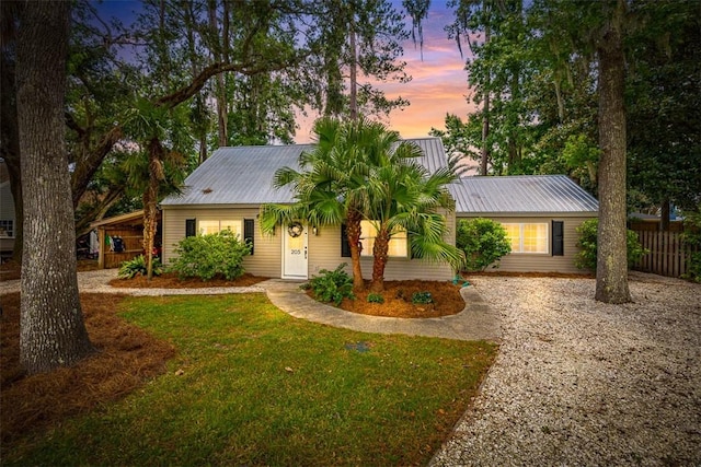 205 Palmetto St, Saint Simons Island, GA 31522 - ranch-style home with driveway, a front yard, and a metal roof