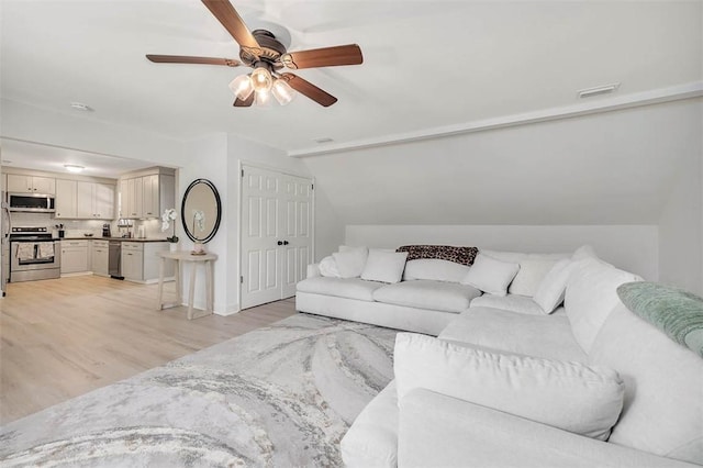 205 Palmetto St, Saint Simons Island, GA 31522 - living room with light wood finished floors, ceiling fan, and lofted ceiling