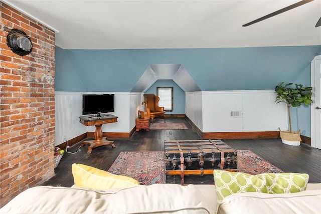 interior space featuring vaulted ceiling, wood finished floors, and visible vents