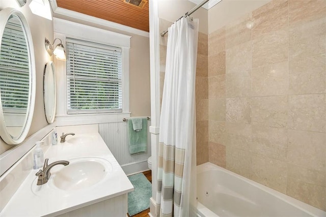 bathroom featuring double vanity, ornamental molding, shower / tub combo, and a sink