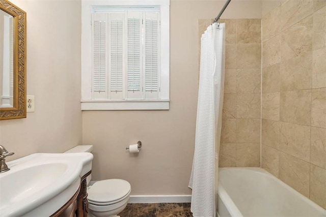 full bathroom featuring vanity, toilet, shower / tub combo, and baseboards