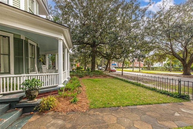 view of yard with covered porch