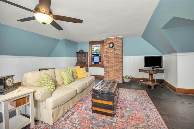 living room featuring ceiling fan, wood finished floors, wainscoting, and vaulted ceiling