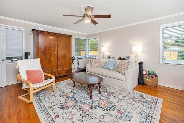 living room with wood finished floors, baseboards, and ornamental molding