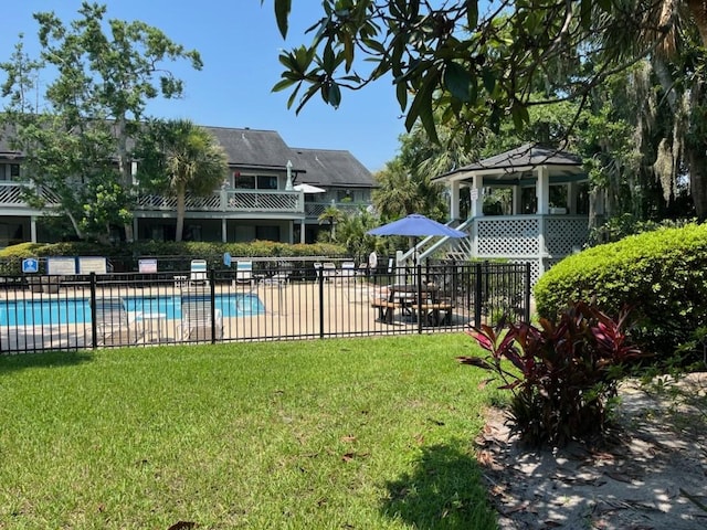 view of pool featuring a yard