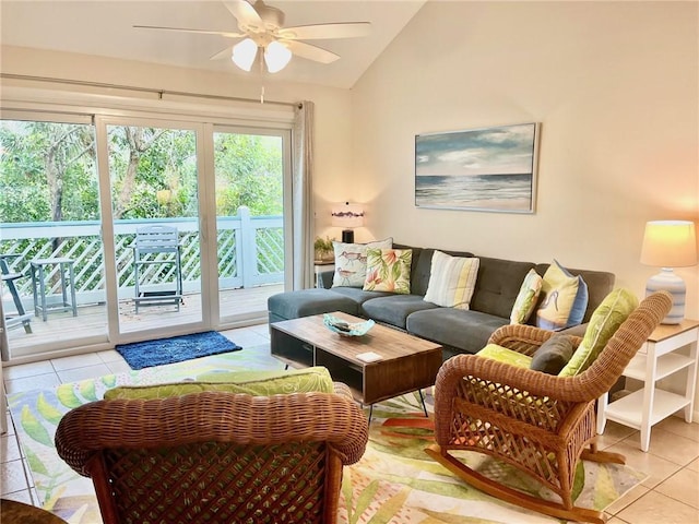 living room with ceiling fan, light tile patterned flooring, and lofted ceiling