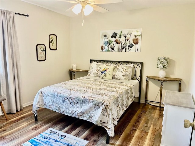 bedroom featuring ceiling fan and dark hardwood / wood-style floors