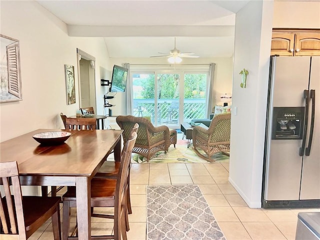 dining room featuring ceiling fan, light tile patterned flooring, and lofted ceiling