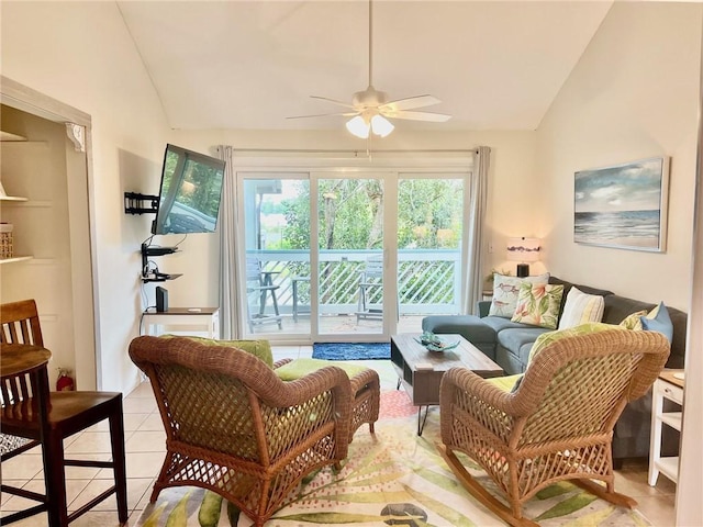 sitting room with ceiling fan, lofted ceiling, and light tile patterned floors