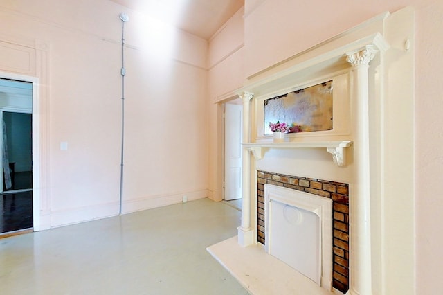 415 Dewey St, Waycross, GA 31501 - unfurnished living room featuring finished concrete flooring and a fireplace with raised hearth