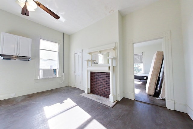 415 Dewey St, Waycross, GA 31501 - unfurnished living room with cooling unit, a ceiling fan, wood finished floors, and a tile fireplace