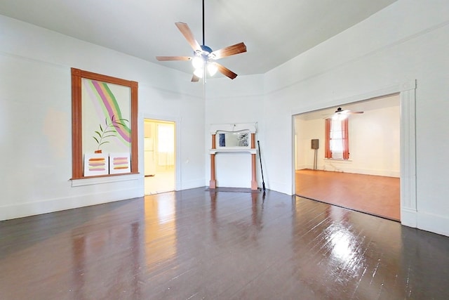 415 Dewey St, Waycross, GA 31501 - unfurnished living room featuring ceiling fan, wood finished floors, and a towering ceiling