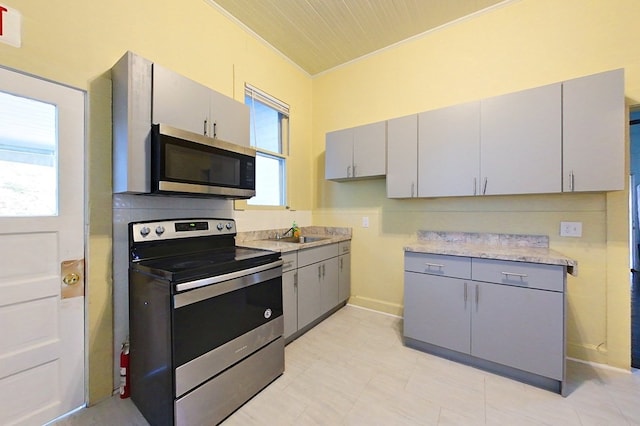415 Dewey St, Waycross, GA 31501 - kitchen with appliances with stainless steel finishes, gray cabinetry, and light countertops
