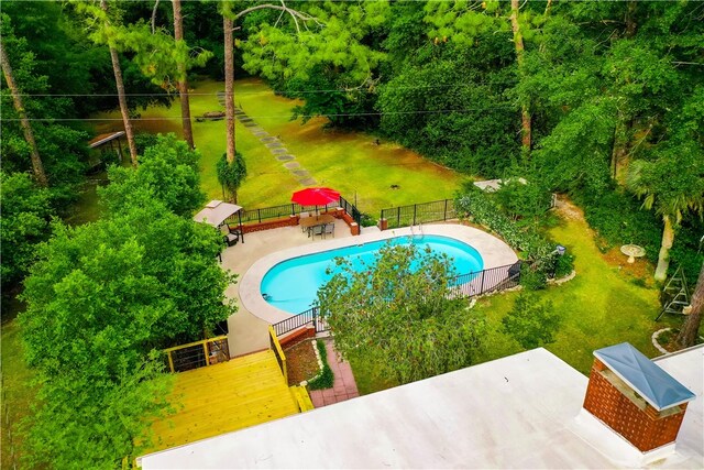 view of pool featuring fence, a patio area, and a deck