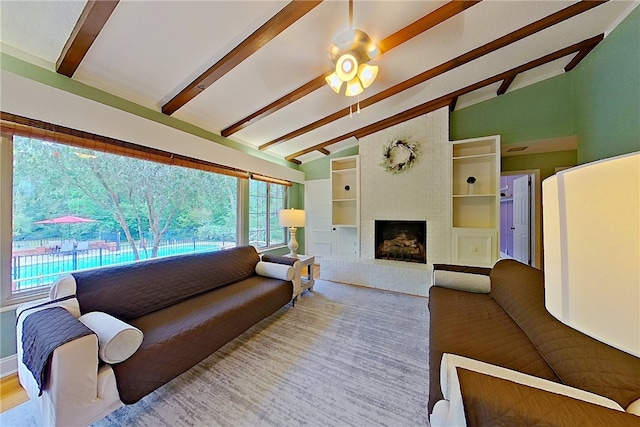 living room with healthy amount of natural light, a brick fireplace, and ceiling fan