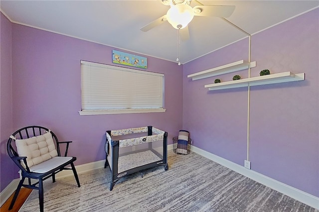 sitting room featuring ceiling fan and baseboards