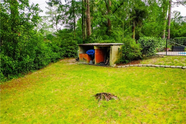 view of yard featuring a shed and an outdoor structure