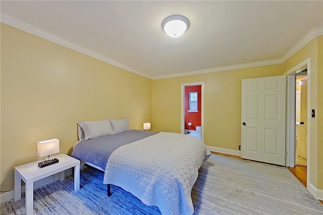 bedroom with crown molding, baseboards, and light wood finished floors