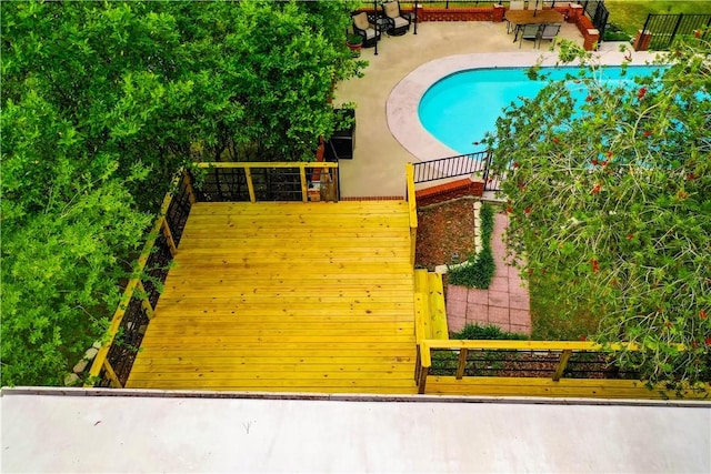 gate featuring fence and a patio area