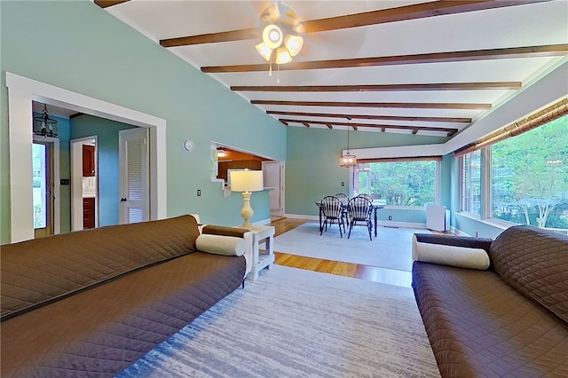 living area with wood finished floors, a ceiling fan, and baseboards