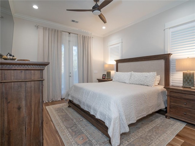 bedroom with ceiling fan, light hardwood / wood-style floors, and crown molding