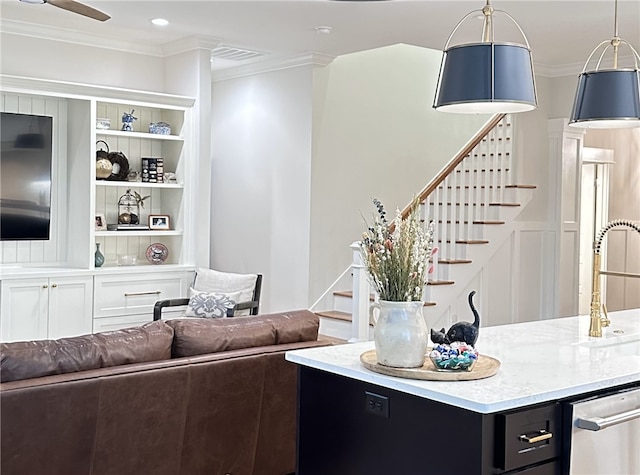 living room with ceiling fan, sink, and crown molding