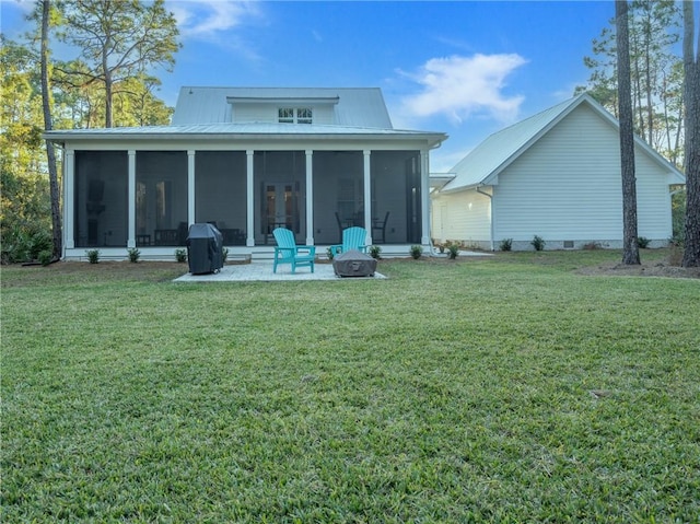 back of property featuring a sunroom and a lawn