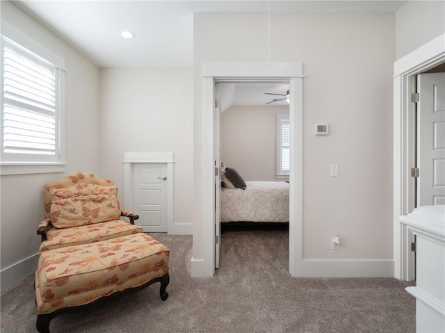 living area featuring carpet floors, a healthy amount of sunlight, and ceiling fan