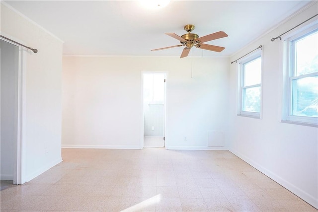 empty room featuring crown molding and ceiling fan